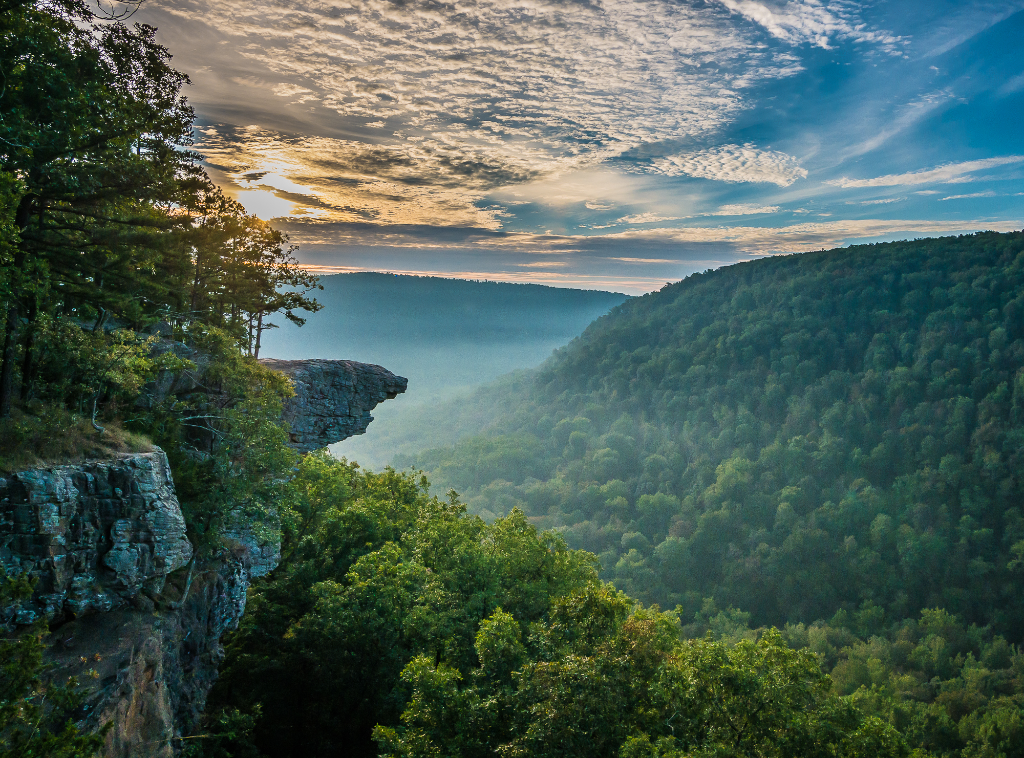 Rolling green Ozarks landscape in Northwest Arkansas, with land and homes across the region