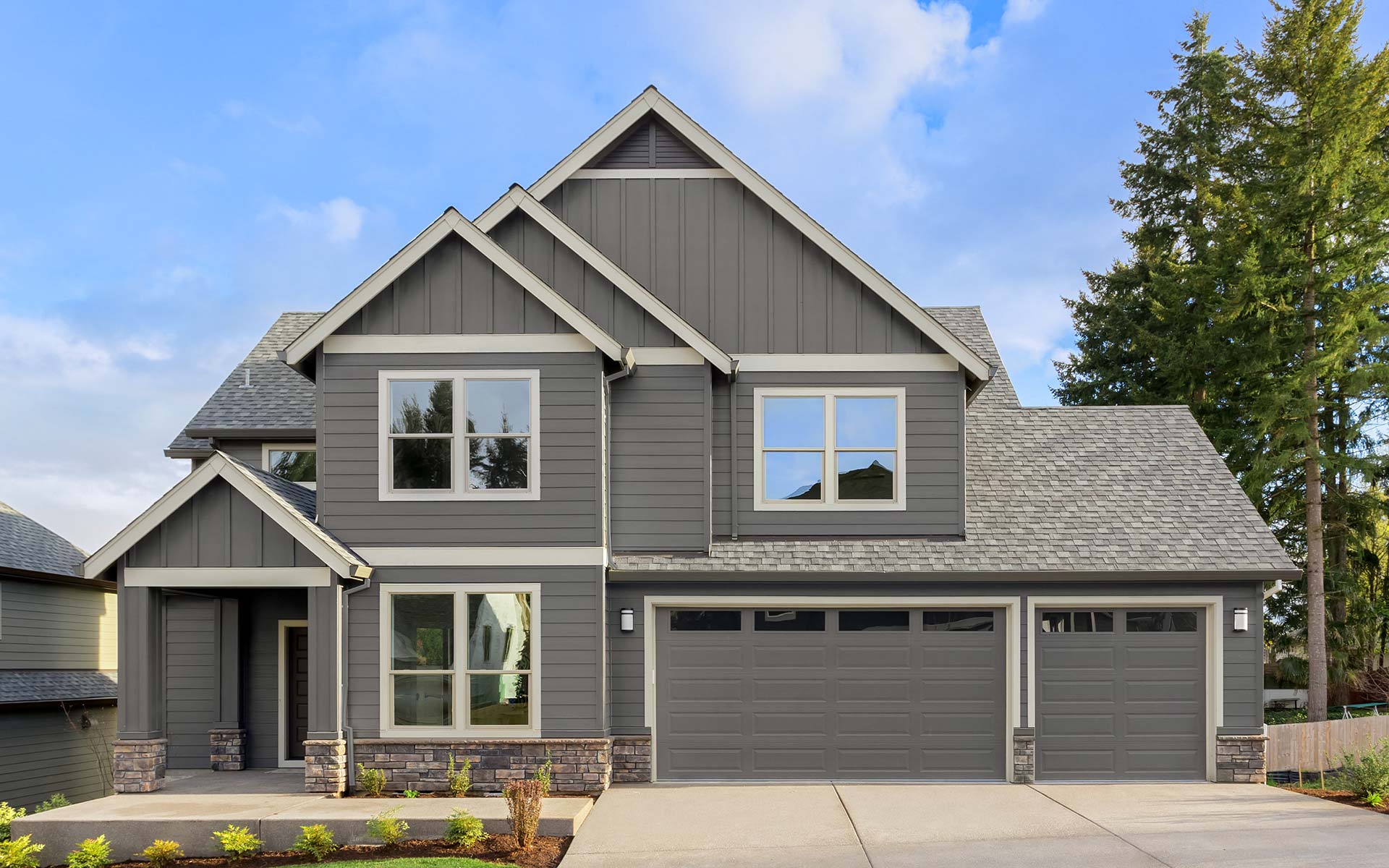 Newly built spec home exterior with clean landscaping